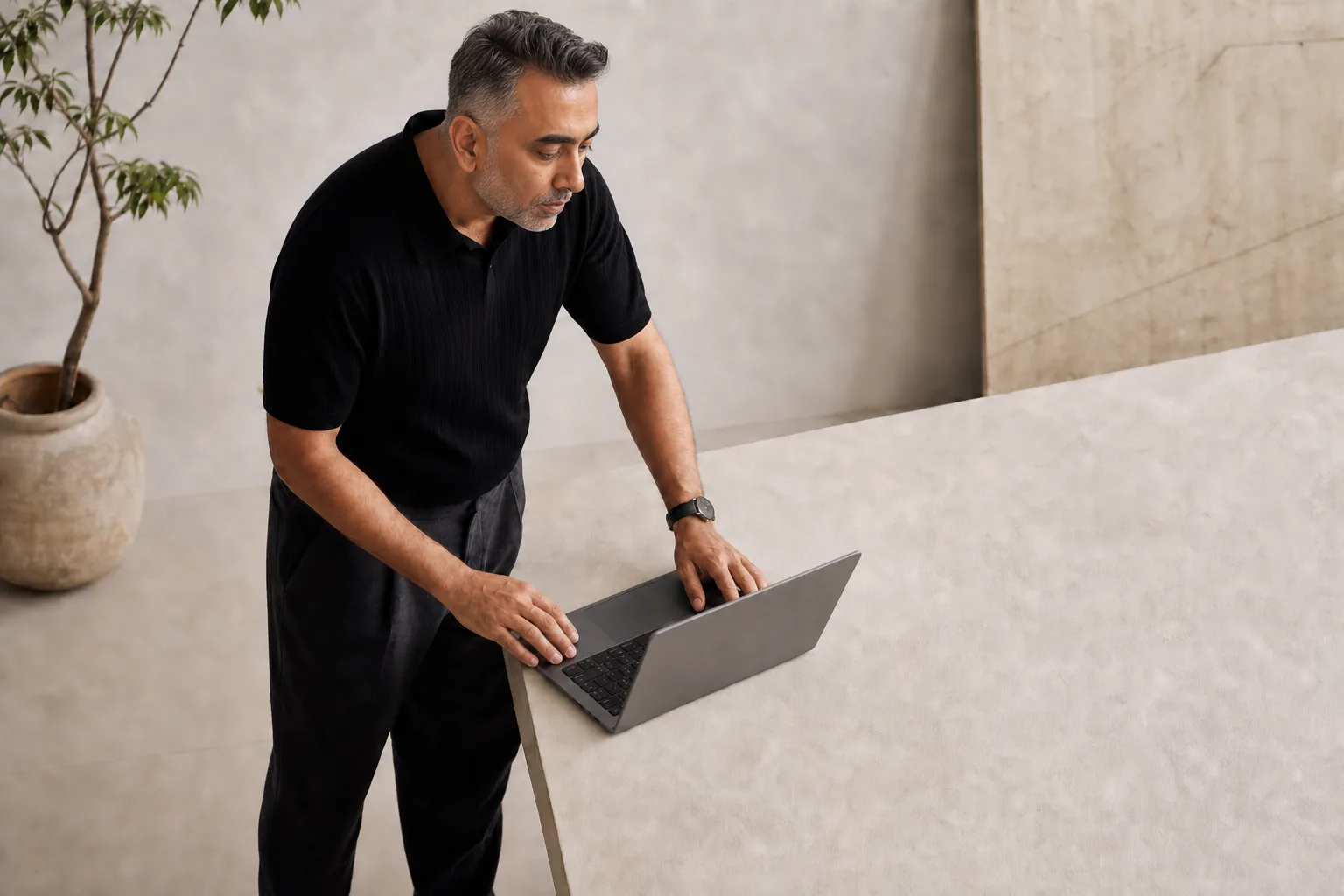 AJ working at a laptop